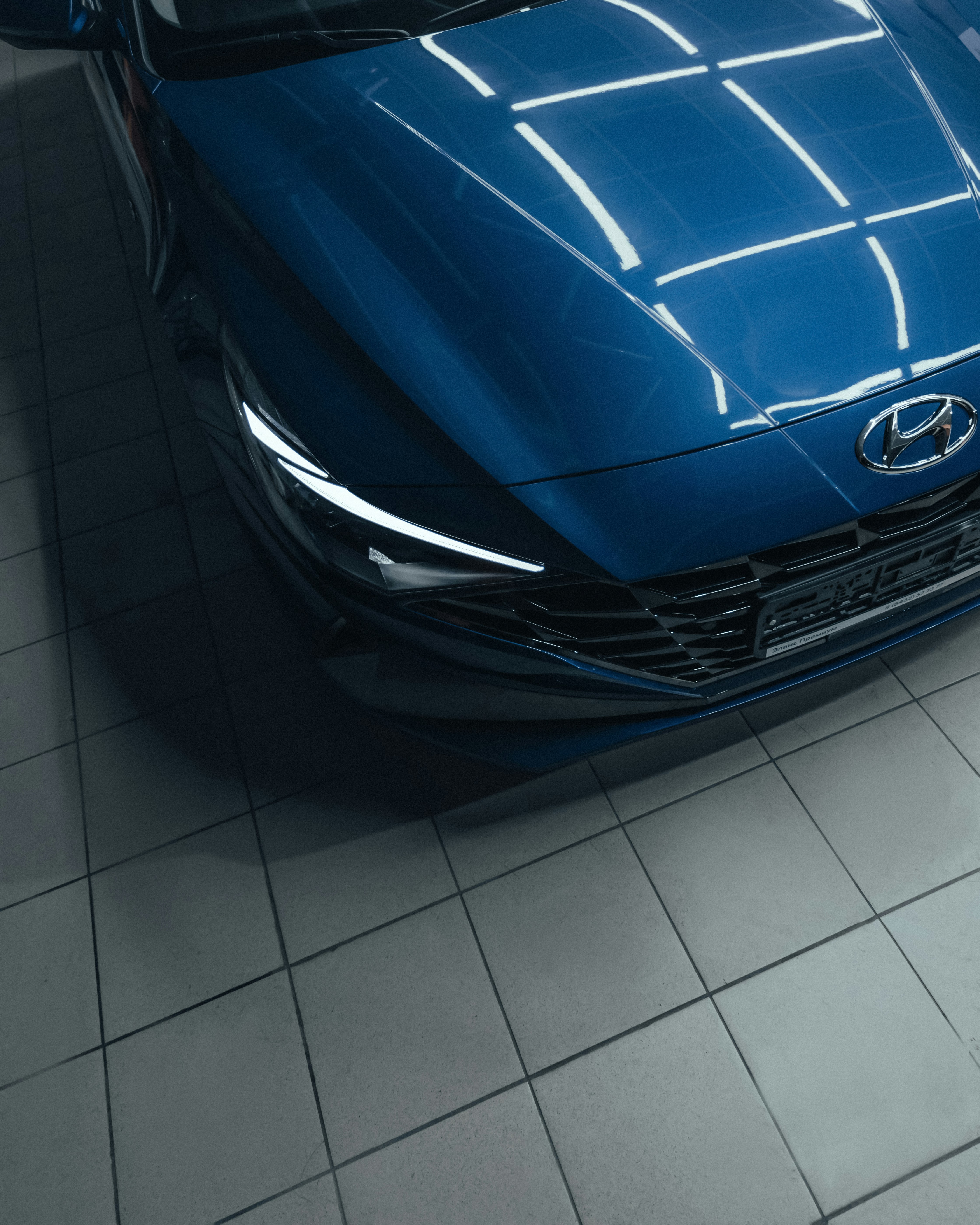 blue car on white floor tiles